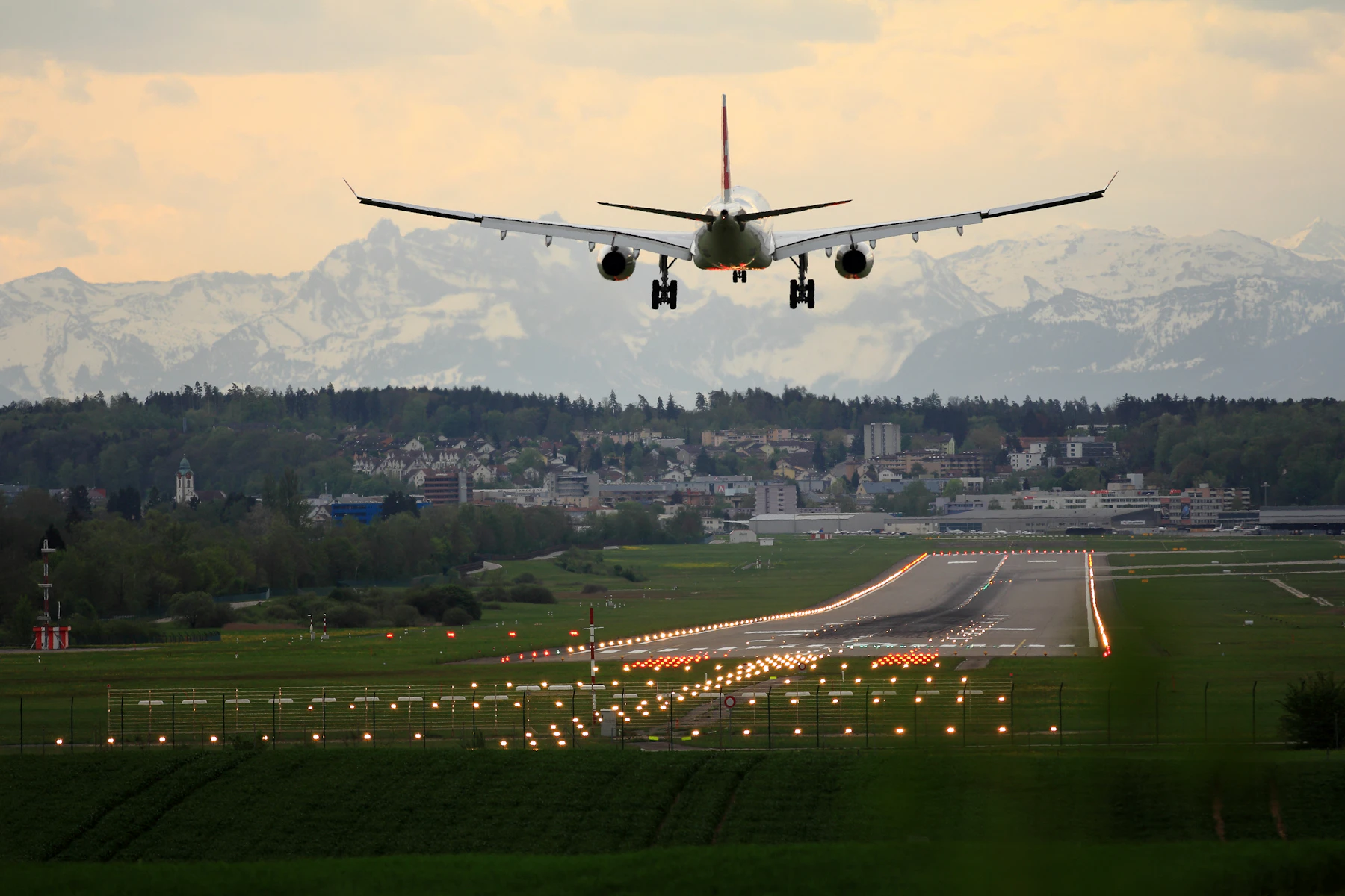 Airliner on final approach over runway lights