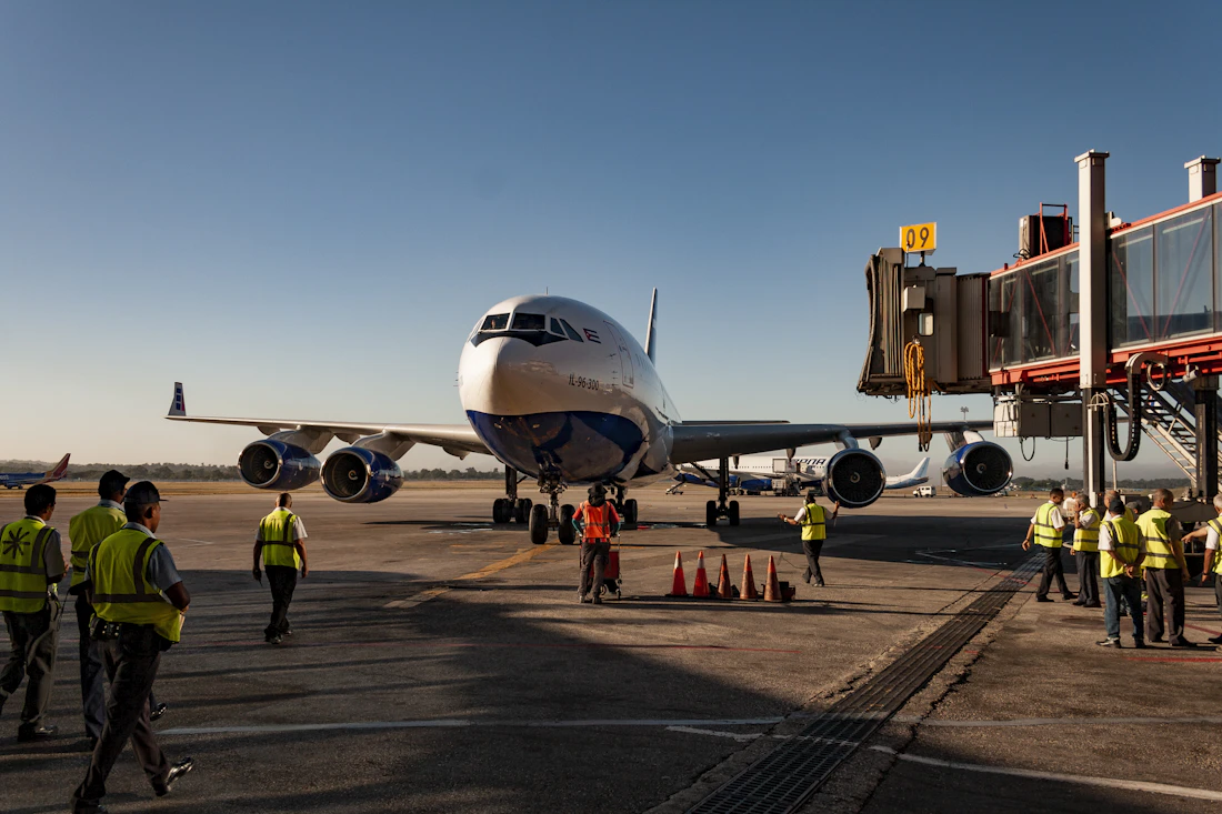 Ground crew beside an airliner at the gate