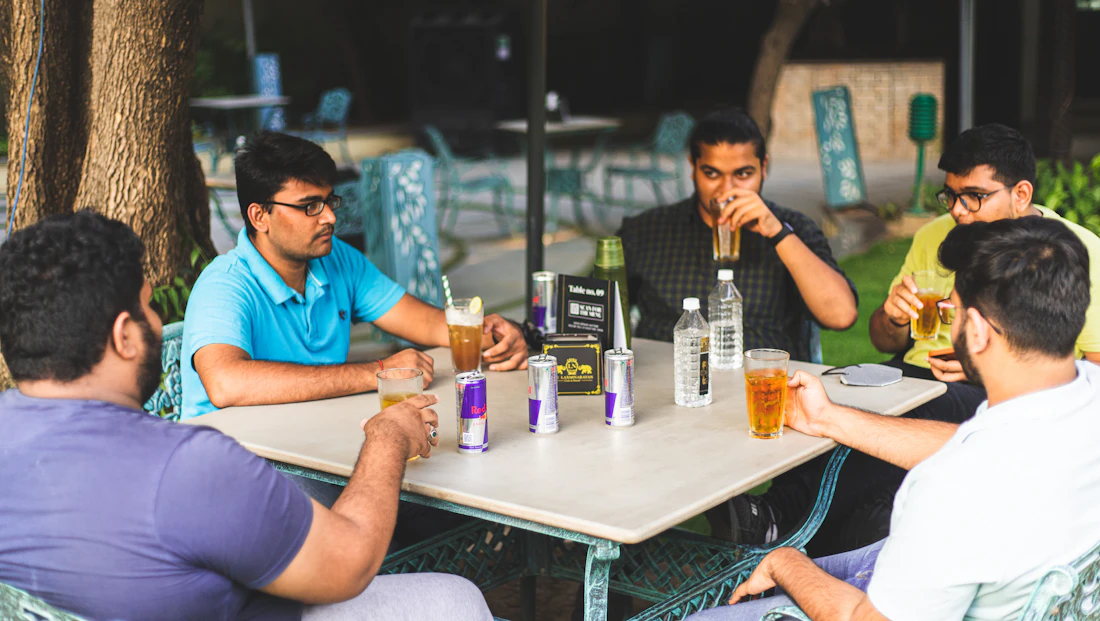Students talking at a cafe table