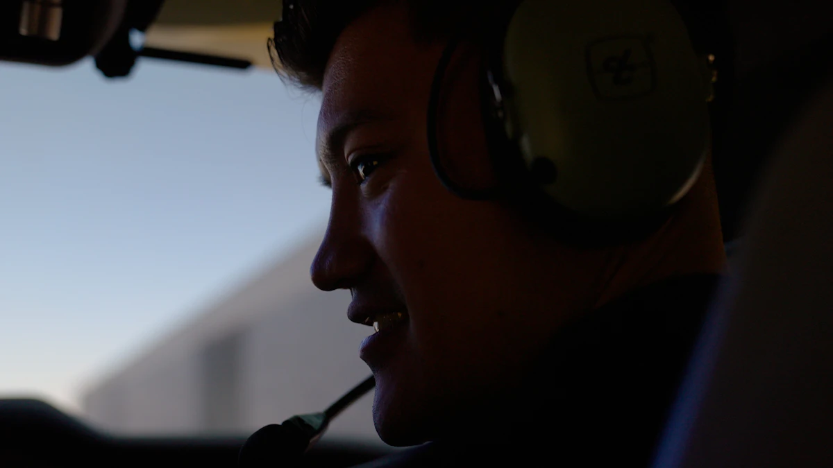 A young pilot wearing a headset in the cockpit