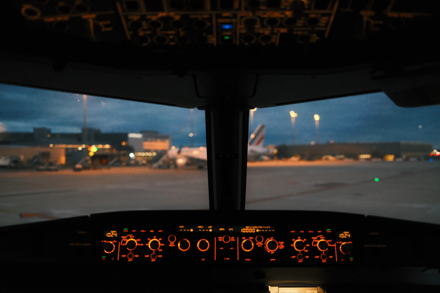 Airliner cockpit at dusk on the apron